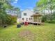 Charming backyard with a two-story home, a large deck, and a gazebo at 5504 Cumberland Plain Dr, Raleigh, NC 27616
