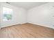 This spacious bedroom features hardwood floors, a large window, and ample natural light at 5504 Cumberland Plain Dr, Raleigh, NC 27616