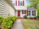 Close up of home's front door, with walkway and manicured landscaping at 5504 Cumberland Plain Dr, Raleigh, NC 27616