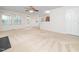 Spacious living room with carpet, ceiling fan, and access to the kitchen and backyard at 5504 Cumberland Plain Dr, Raleigh, NC 27616