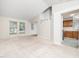Open living room with neutral carpet, bright natural light, and access to kitchen and stairs at 5504 Cumberland Plain Dr, Raleigh, NC 27616