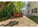 Backyard with wooden deck, surrounded by mature trees, creating a peaceful outdoor area at 5801 Forest Point Rd, Raleigh, NC 27610
