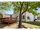 Wooden deck and backyard, enhanced by beautiful trees and greenery in a lush landscape at 5801 Forest Point Rd, Raleigh, NC 27610
