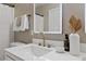 Bright bathroom featuring a modern vanity with gold fixtures and decorative mirror at 5801 Forest Point Rd, Raleigh, NC 27610