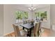 Sunlit dining room with a modern chandelier and views of the outdoors at 5801 Forest Point Rd, Raleigh, NC 27610