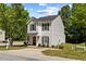 Well-maintained two-story home featuring a tidy lawn and driveway, enhanced by mature trees and leafy bushes at 5801 Forest Point Rd, Raleigh, NC 27610