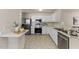 Well-lit kitchen with stainless steel appliances and ample counter space at 5801 Forest Point Rd, Raleigh, NC 27610