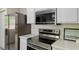 Modern kitchen featuring stainless steel appliances, sleek countertops, and white cabinets at 5801 Forest Point Rd, Raleigh, NC 27610