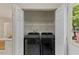Convenient laundry area with a new washer and dryer and storage shelving at 5801 Forest Point Rd, Raleigh, NC 27610