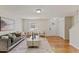Bright and airy living room featuring hardwood floors and ample seating at 5801 Forest Point Rd, Raleigh, NC 27610