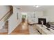 Open-concept living space with hardwood floors, fireplace, and staircase at 5801 Forest Point Rd, Raleigh, NC 27610