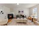 Inviting living room with a fireplace, hardwood floors, and comfortable seating at 5801 Forest Point Rd, Raleigh, NC 27610
