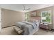 Comfortable main bedroom featuring a king-size bed, neutral tones, and two bright windows at 5801 Forest Point Rd, Raleigh, NC 27610