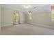 Spacious bedroom features neutral carpet, fresh paint, and abundant natural light from two windows at 605 Glen Eden Dr, Raleigh, NC 27612