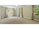 Bright bedroom featuring three windows with patterned curtains and natural light at 605 Glen Eden Dr, Raleigh, NC 27612