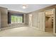 Spacious bedroom featuring a walk-in closet, window with valance, and ensuite bathroom at 605 Glen Eden Dr, Raleigh, NC 27612