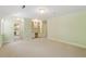 Bright bedroom with built-in desk/shelving units and a view into an adjoining bathroom at 605 Glen Eden Dr, Raleigh, NC 27612