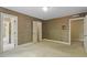Bedroom featuring wallpapered walls and three doorways to other rooms at 605 Glen Eden Dr, Raleigh, NC 27612
