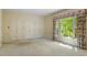 Bright bedroom featuring plush carpeting, triple closets, and a large window with patterned valance and drapes at 605 Glen Eden Dr, Raleigh, NC 27612