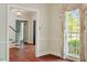 Charming dining room featuring hardwood floors, a chandelier, and large window with a floral patterned curtain at 605 Glen Eden Dr, Raleigh, NC 27612
