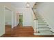Traditional foyer with hardwood floors, and carpeted stairs, leading to the upper level of the home at 605 Glen Eden Dr, Raleigh, NC 27612