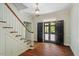 Elegant foyer with hardwood floors, a staircase, and a black paneled door, creating a welcoming entrance at 605 Glen Eden Dr, Raleigh, NC 27612