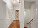 Upstairs hallway with hardwood flooring, and hallway view to bathroom with floral wallpaper at 605 Glen Eden Dr, Raleigh, NC 27612