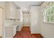 Hallway featuring a built-in desk, ample storage and brick flooring at 605 Glen Eden Dr, Raleigh, NC 27612