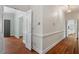 Hallway view featuring hardwood floors and architectural details at 605 Glen Eden Dr, Raleigh, NC 27612
