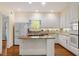 Well-lit kitchen with custom cabinetry, stainless steel appliances, and a center island at 605 Glen Eden Dr, Raleigh, NC 27612