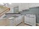 A vintage-style kitchen area features a countertop bar with white cabinetry and appliances at 605 Glen Eden Dr, Raleigh, NC 27612