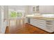 Kitchen with ample counter space, wood flooring and open to a bright living space at 605 Glen Eden Dr, Raleigh, NC 27612
