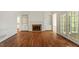 Living room featuring hardwood floors, a fireplace, and built in bookshelves at 605 Glen Eden Dr, Raleigh, NC 27612