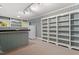 A spacious living room featuring a large wall of shelving and a nearby white refrigerator at 605 Glen Eden Dr, Raleigh, NC 27612