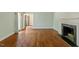 Bright living room with hardwood floors, a fireplace, and large windows, creating a comfortable atmosphere at 605 Glen Eden Dr, Raleigh, NC 27612