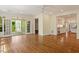 Open living room with hardwood floors and access to an outdoor deck through French doors at 605 Glen Eden Dr, Raleigh, NC 27612