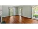 Spacious living room with hardwood floors, large windows, and neutral paint, perfect for entertaining guests at 605 Glen Eden Dr, Raleigh, NC 27612