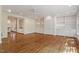 Bright living room featuring hardwood floors, built-in bookshelves, and open access to the kitchen at 605 Glen Eden Dr, Raleigh, NC 27612