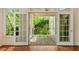 View of the outdoor deck through French doors and window, showcasing the outdoor space at 605 Glen Eden Dr, Raleigh, NC 27612
