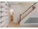 Basement staircase with red runner, white spindles, and a view to the downstairs bathroom at 605 Glen Eden Dr, Raleigh, NC 27612
