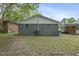 Spacious backyard showcasing the home's gray brick exterior and a well-kept lawn at 606 Cecil Street St, Durham, NC 27707