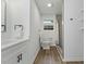 Bathroom featuring a sleek vanity, toilet, shower with modern gray tile and hardwood floors at 606 Cecil Street St, Durham, NC 27707
