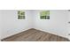 Bedroom featuring hardwood floors, two windows and white walls at 606 Cecil Street St, Durham, NC 27707