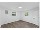 Bedroom featuring hardwood floors, two windows and white walls at 606 Cecil Street St, Durham, NC 27707