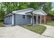 This home's exterior has a gray brick facade, white trim, and well-maintained landscaping at 606 Cecil Street St, Durham, NC 27707