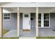 Inviting front entrance with white door, decorative glass, and neutral-toned welcome mat at 606 Cecil Street St, Durham, NC 27707