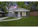 Charming home featuring freshly painted gray brick and inviting front porch in a lush green yard at 606 Cecil Street St, Durham, NC 27707
