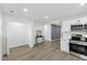 Bright kitchen features stainless steel appliances, white cabinets, and modern finishes at 606 Cecil Street St, Durham, NC 27707