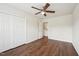 Bedroom with hardwood floors, closet, and ceiling fan, leading into a walk-in closet at 617 Sealine Dr, Cary, NC 27519