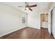 Bedroom with hardwood floors, closet, and ceiling fan, leading into a walk-in attic at 617 Sealine Dr, Cary, NC 27519